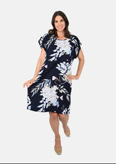 lady wearing tropical print navy blue tunic dress #color_Navy Blue Floral