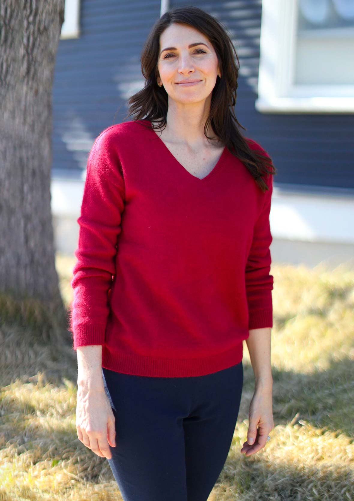 lady wearing long sleeved v-neck red sweater #color_Rufous Red